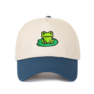 Close-up of green frog embroidery on a contrast color cotton trucker hat with sturdy stitching