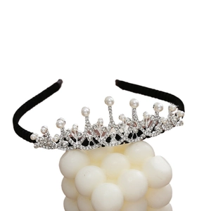 Silver crown headband with sparkling rhinestones and pearls on a minimalist white base