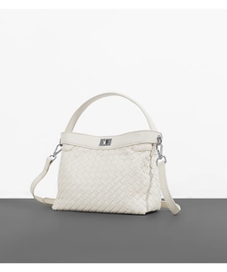 Macro shot of white woven leather texture with silver metal twist lock on a Kelly bag