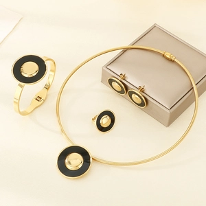 Close-up of a gold and black enamel round jewelry set with necklace and bracelet