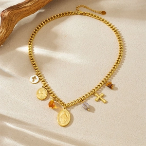 Detailed view of 18K gold plated saint medals and cross charms on beaded necklace set