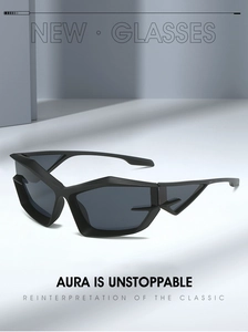 Detail view of thick black irregular geometric frame and dark grey futuristic lenses