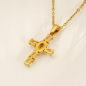 Retro gold cross pendant necklace with sparkling cubic zirconia on a beige ripple texture