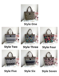 Detailed view of various printed canvas tote bags with wooden buttons and braided handles