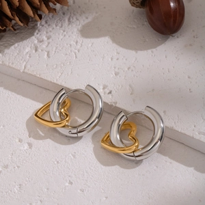 Minimalist two-tone intertwined hoop earrings featuring silver circles and golden hearts