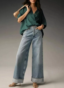 Women's dark green silky short sleeve shirt styled with light blue high waist jeans