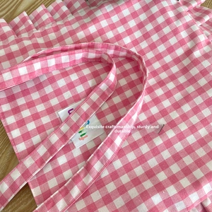 Detailed close-up of pink gingham tote bag showing fine stitching and canvas texture