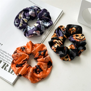 Three-pack Halloween satin scrunchies featuring ghost, pumpkin and bat festive patterns