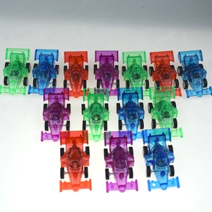 Array of colorful transparent formula race car toys for children in green, blue, and orange