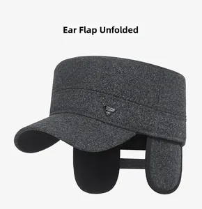 Detail of gray winter flat top hat with unfolded earflaps and metal decoration