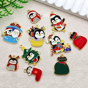 Macro view of Christmas penguin and holiday tree enamel charms for DIY earring crafts