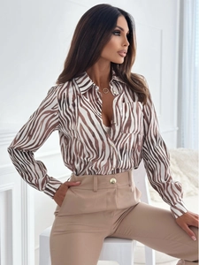 Detail of a woman's zebra print long-sleeved shirt with brown and white animal patterns