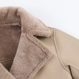 Detail of double-sided lapel coat showing shearling lining and premium leather stitching