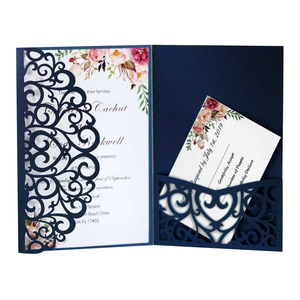 Navy blue laser cut wedding invitation set with delicate floral patterns and inserts