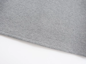 Macro detail of double-needle stitching and grey heather knit fabric on a long skirt
