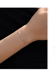 Detail of a minimalist S925 sterling silver thin chain bracelet with sparkling zircons