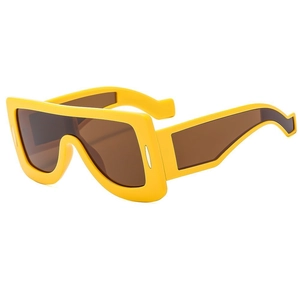 Futuristic yellow oversized geometric sunglasses with brown lenses and wide temple arms