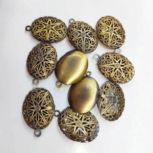 Vintage oval hollow locket in antique bronze finish with intricate starburst pattern