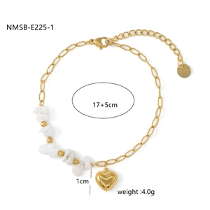 Detailed view of a gold stainless steel bracelet with white stones and heart pendant
