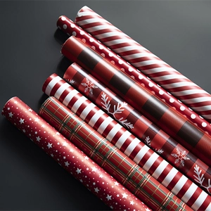 Red plaid and snowflake Christmas wrapping paper rolls for festive holiday gift packaging