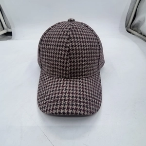Close-up of retro brown and white houndstooth pattern on a structured baseball cap