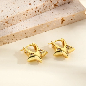 Exaggerated gold hollow star earrings with zircon inlay and sunburst engraving texture