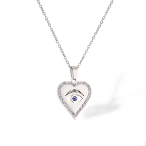 Detailed view of silver heart pendant with evil eye motif and sparkling zircon stones