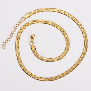 Close-up of golden flat snake chain necklace with lobster clasp and adjustable link chain