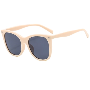 Retro oversized beige sunglasses with dark gray lenses and metallic rivet accents