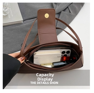 Internal view of brown shoulder bag showing large capacity for phone and cosmetics