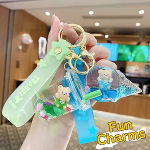 Cute liquid quicksand keychain featuring a blue ice cream and green tea cup with mini bears
