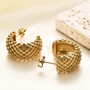 Detailed macro view of 14K gold-plated C-shaped earrings with unique mesh texture surface
