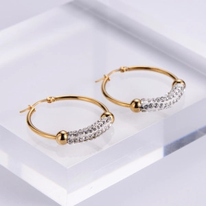 Elegant gold-plated hoop earrings with sparkling pave-set cubic zirconia on clear stand