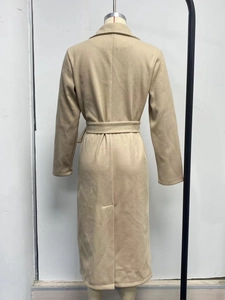 Back view of long camel wool coat with waist tie and hem slit detail
