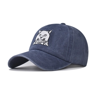 Classic washed denim baseball cap featuring a white cat embroidery from a side angle view