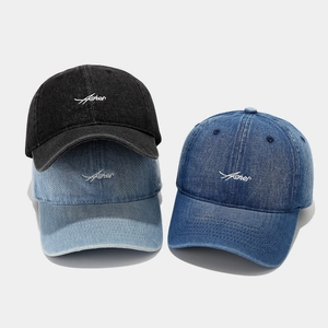 Denim baseball caps with Asher embroidery in black and blue washes on a white background
