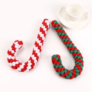 Macro detail of red and white woven cotton rope candy cane dog toys for Christmas