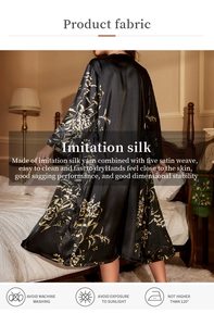 Detail of black imitation silk robe featuring floral patterns and smooth satin texture