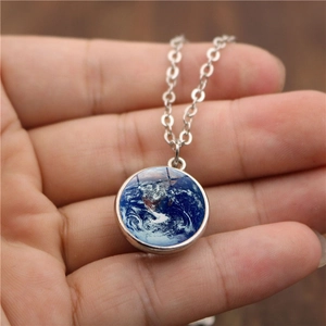 Detailed close-up of a double-sided crystal glass ball necklace with earth pattern globe pendant