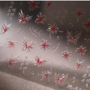 Macro shot of 3D butterfly nail stickers with laser holographic finish and floral details