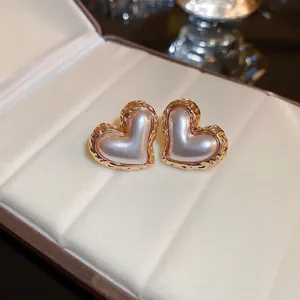Elegant French vintage heart-shaped pearl earrings with textured gold-tone metal borders