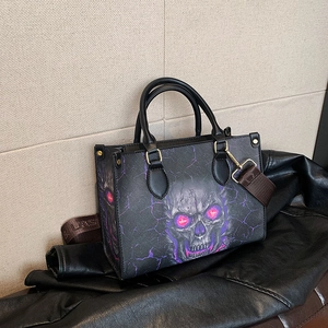 Gothic skull tote bag with purple lightning print and woven strap on leather jacket