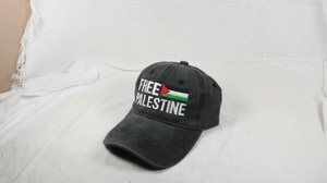 Close-up of Free Palestine embroidery on a vintage washed black cotton baseball cap