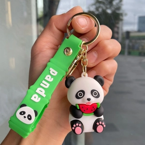 Close-up of cute silicone panda keychain with green strap and golden metal ring