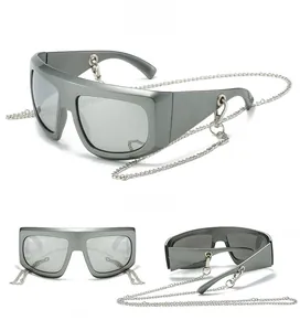 Detail view of Y2K oversized sunglasses with matte grey frame and silver metal chains