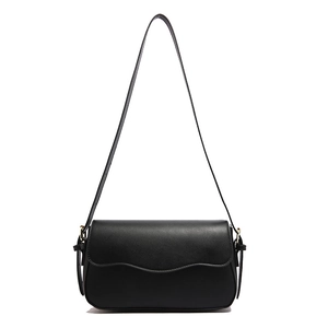 Minimalist black rectangular leather crossbody bag with adjustable strap and gold hardware
