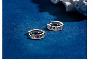 Detailed macro view of S925 sterling silver hoop earrings with vibrant colorful gemstones