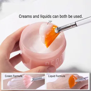 Fan-shaped acid facial mask brush with soft orange bristles and clear handle for skincare