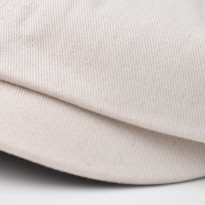 Close-up of beige twill cotton beret featuring fine weaving and neat edge stitching details
