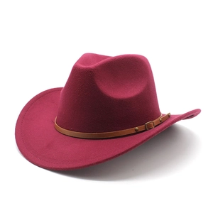 Detail of dark red western felt cowboy hat with brown studded leather belt decoration